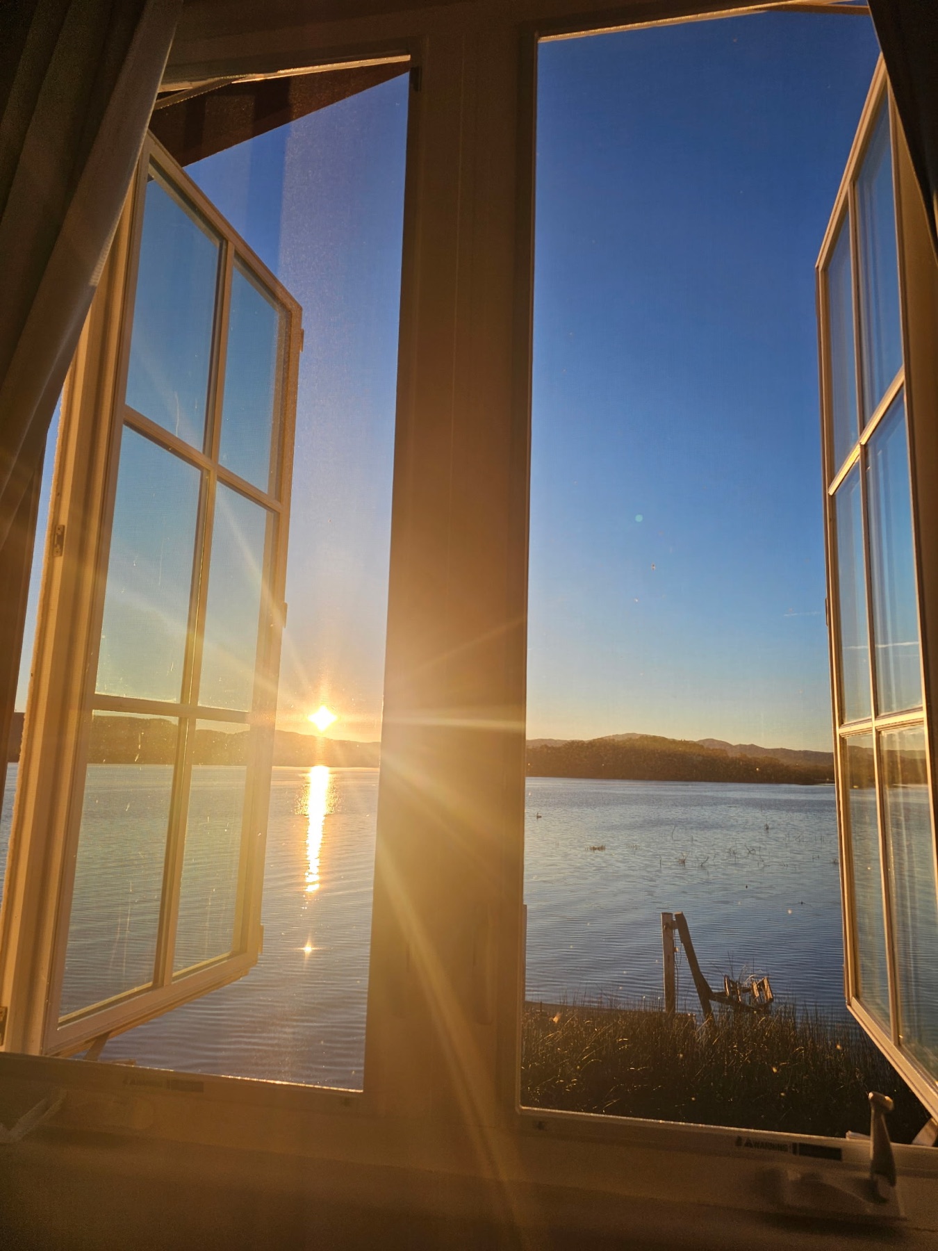 Sunrise over Clear Lake through the lodge windows