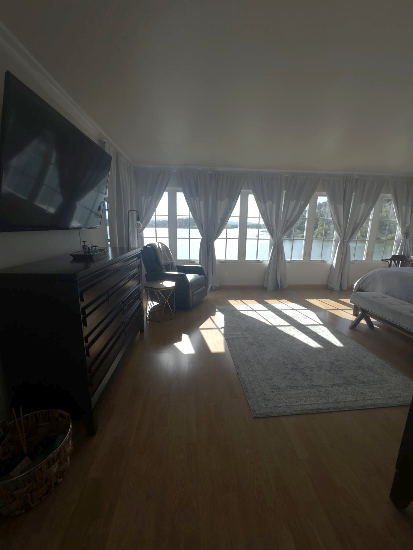 Primary suite sitting area beside the lake-facing windows