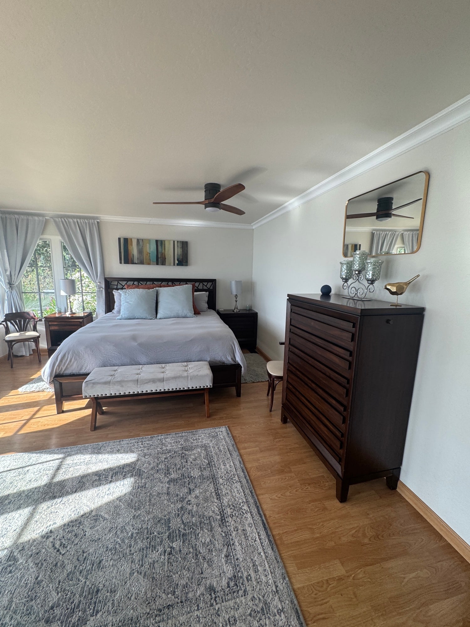 Bright primary bedroom with wide lake-facing windows